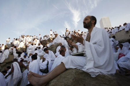 A Muslim pilgrim prays on Mount Mercy on the plains of Arafat outside the holy city of Mecca December 7, 2008. More than two million Muslims began the haj pilgrimage on Saturday, heading to a tent camp outside Mecca to follow the route Prophet Mohammad took 14 centuries ago. REUTERS/Ahmed Jadallah (SAUDI ARABIA)