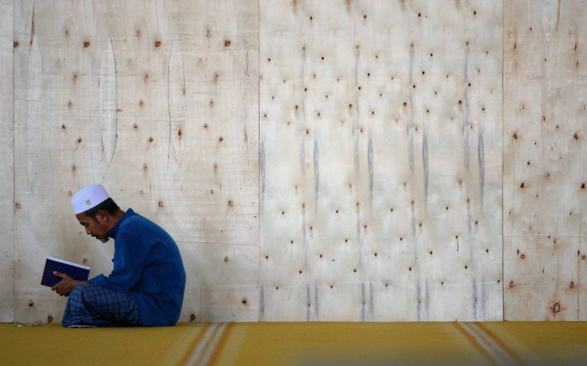 Man reading Quran learning student