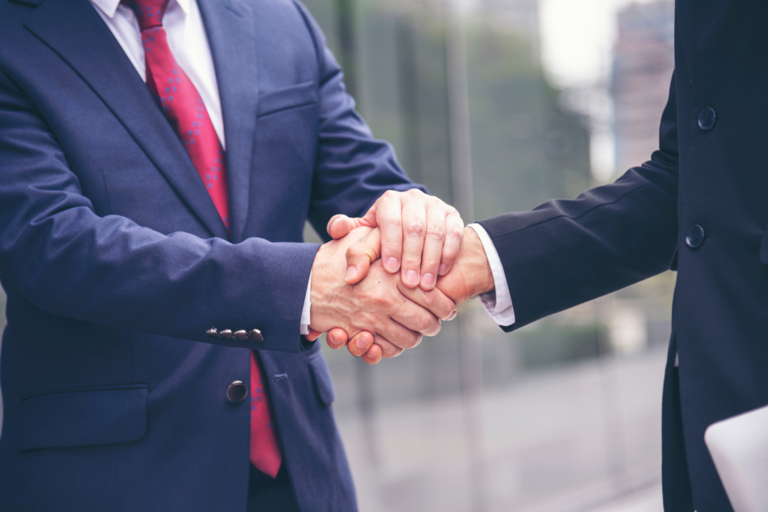 Two men shaking hands on an agreement/promise